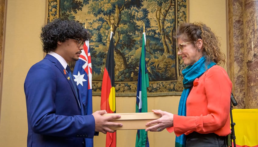 Manchester Museum Director Esme Ward formally hands over 43 objects to a representative of five Aboriginal communities.